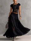 Ginevra · Set composto da top trasparente con pannelli in pizzo nero e gonna maxi plissettata